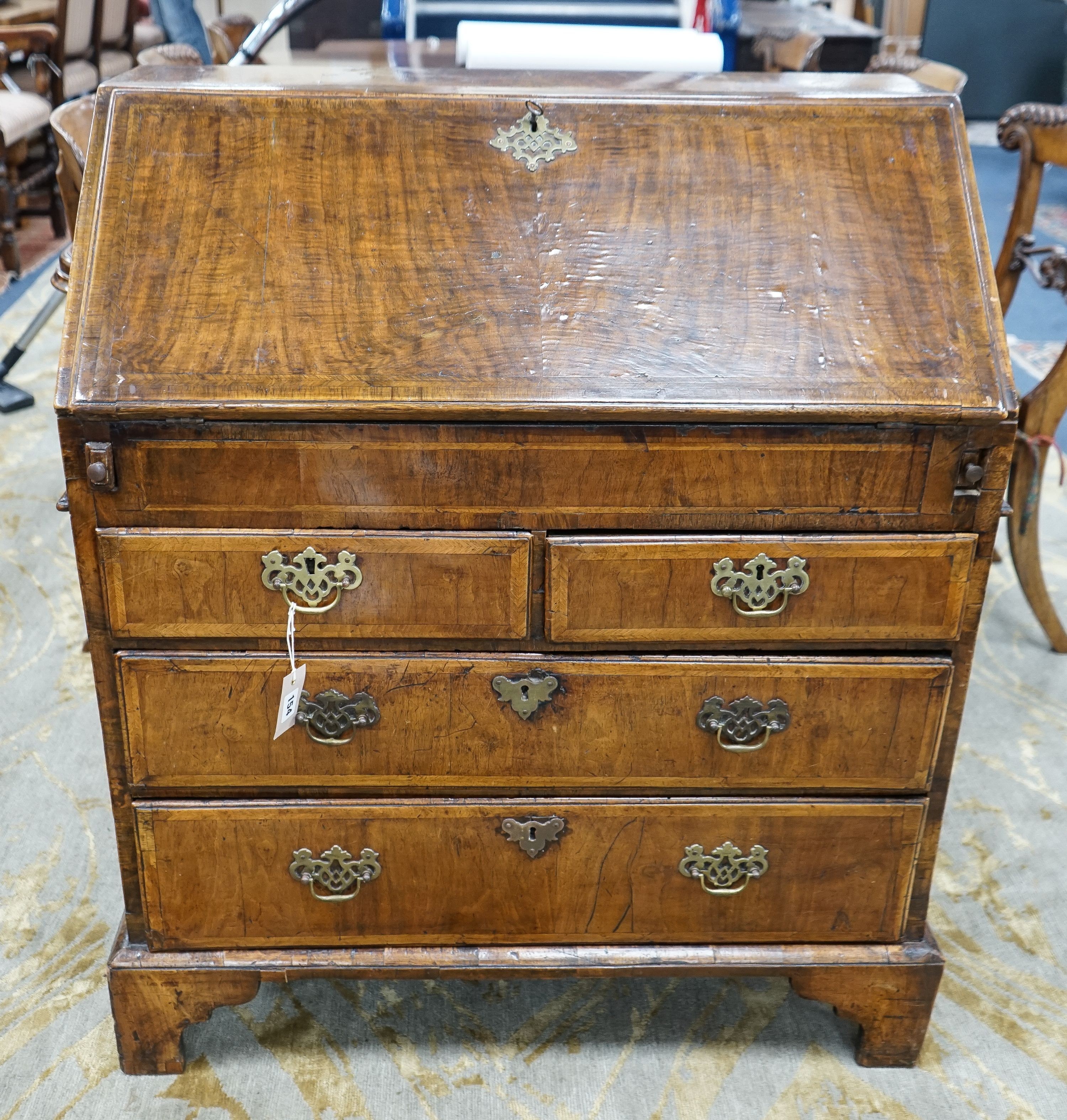 A George I feather banded walnut bureau with well interior, width 83cm, depth 48cm, height 98cm